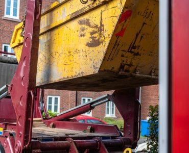 Big Yellow rubbish skip near the house. Rubbish removal hire during renovation of the house