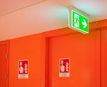 Bright green safety exit signal. Help to escape in an emergency.