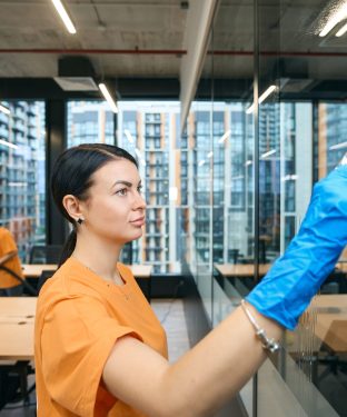 Qualified employees of the cleaning company clean and disinfect all surfaces in the coworking space