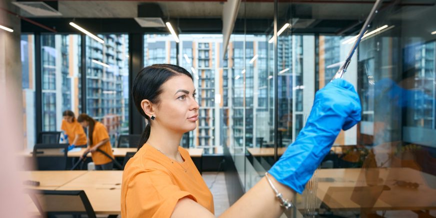 Qualified employees of the cleaning company clean and disinfect all surfaces in the coworking space
