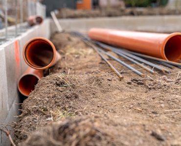 plastic pipe for sewage network in the base plate at the construction site.