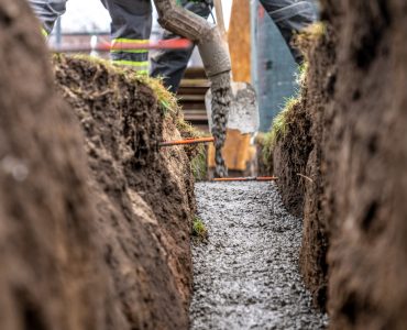 pour concrete from the mixer of the foundation of the building in the ground.