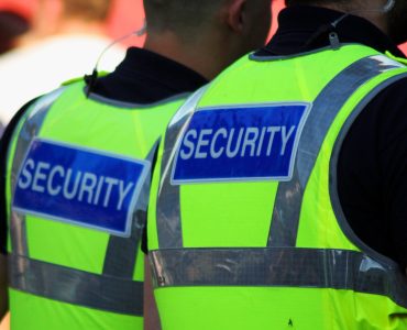 stock-photo-image-of-two-male-security-guards-with-bright-tops-on-76002502-2880w